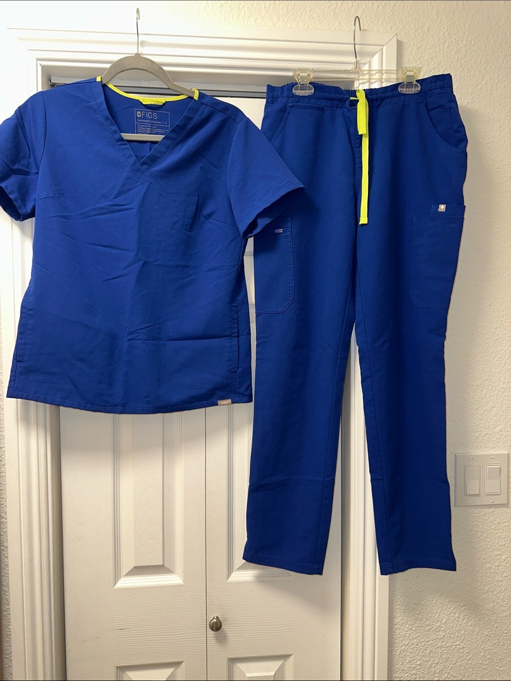 Figs blue scrubs with neon yellow string